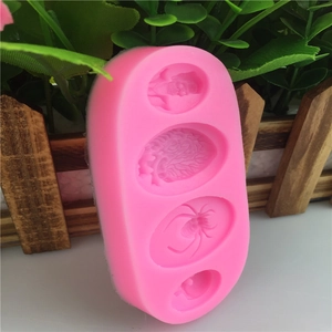 Pink silicone mold featuring spider and skull designs for fondant cake baking and DIY crafts