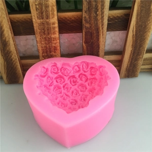 Pink heart-shaped silicone mold with detailed rose floral patterns for cake baking
