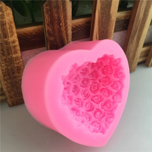 Pink heart-shaped silicone mold with 3D rose flower textures for baking and DIY crafts