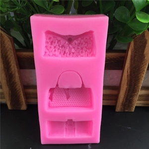 Pink silicone mold featuring three distinct handbag shapes for fondant and cake decorating