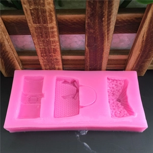 Pink silicone mold featuring three distinct handbag designs for fondant and cake decorating