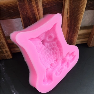 Pink silicone owl mold with detailed feather patterns for handmade soap and cakes