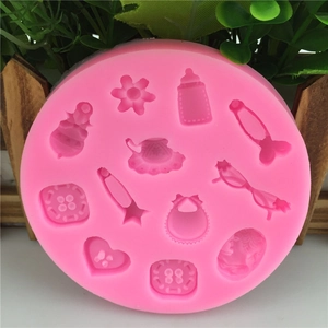 Pink silicone fondant mold with buttons, flowers, and baby bottle shapes for DIY baking