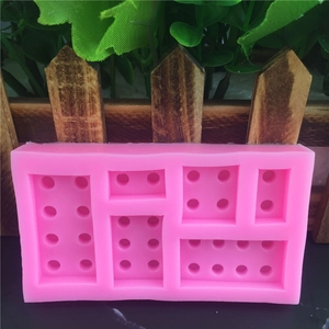 Pink silicone baking mold with 3D building block shapes for cakes and fondant
