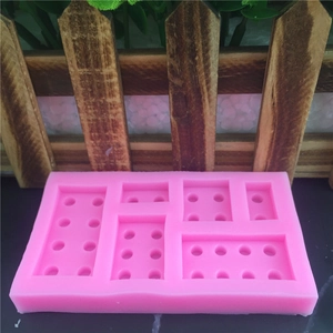 Pink silicone mold featuring building block brick shapes for chocolate and fondant cakes
