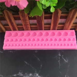 Pink rectangular silicone fondant mold with detailed leaf and petal textures for cakes