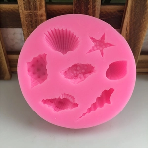 Pink round silicone mold featuring seashell and starfish shapes for cake decorating
