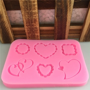 Pink silicone mold with heart, square, and round cavities for DIY baking and crafts