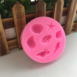Pink silicone mold for fondant and chocolate featuring sea shells, starfish, and scallop shapes