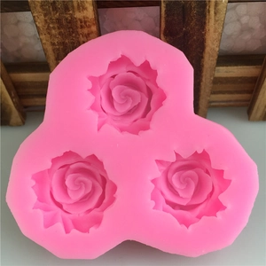 Pink silicone mold featuring three detailed rose flower shapes for cake decorating