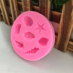 Pink silicone mold with starfish and seashell shapes for fondant and cake decorating