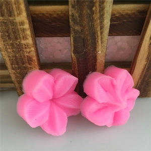 Pink silicone mold set featuring two 3D plum blossom shapes for fondant and cake decoration