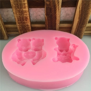 Pink silicone mold featuring two bear cavities for fondant and cake decorating