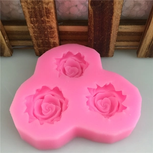 Pink silicone mold featuring three 3D rose flower shapes for fondant and chocolate cake decor