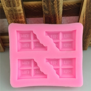 Pink silicone chocolate bar mold with MILK lettering and bite mark design