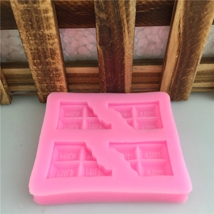 Pink silicone chocolate bar mold with four slots and milk text engraving for DIY baking