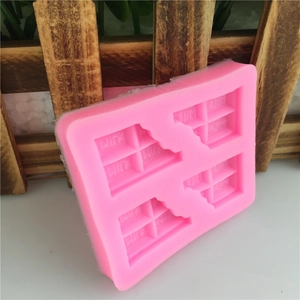 Pink silicone chocolate bar mold with four cavities and embossed MILK text detail