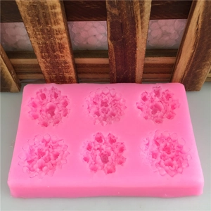 Pink silicone mold featuring six floral cavities for fondant cake and soap making