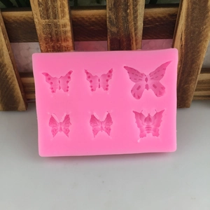 Pink silicone mold with six different bow designs for DIY cake fondant and baking