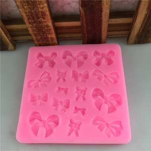Pink silicone mold featuring 16 different bow shapes for DIY cake fondant and baking