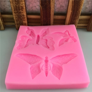 Pink silicone butterfly mold set with three detailed patterns for fondant cake decorating