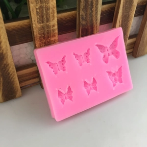 Pink silicone mold featuring six different bow patterns for fondant and DIY cake decorating