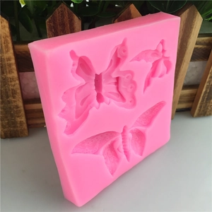 Pink silicone butterfly mold for cake decorating with three different butterfly designs