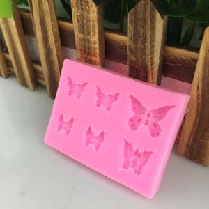 Pink silicone mold with six different bow shapes for DIY fondant cake decoration