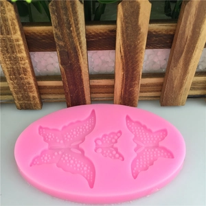 Pink silicone mold featuring three butterflies with wing textures for cake decorating