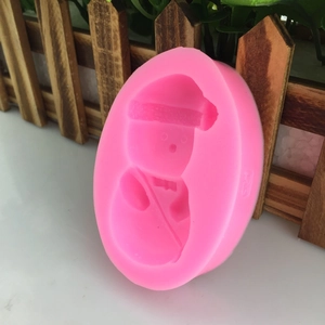 Pink silicone mold featuring a cute cartoon snowman for fondant cake and soap making