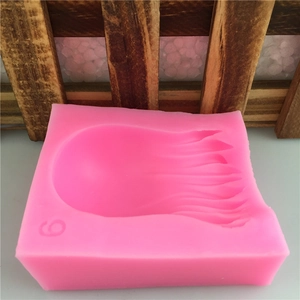 Pink silicone mold for fondant cake decorating featuring wave and jellyfish textures