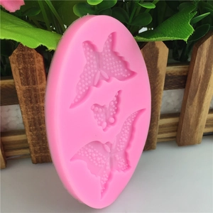 Pink silicone butterfly mold for fondant cake decorating with three detailed sizes