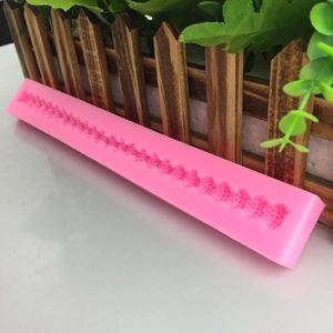 Pink silicone fondant mold with floral vine patterns for cake borders and baking decor