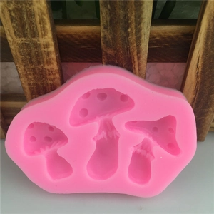 Pink silicone mold featuring three distinct mushroom shapes for fondant cake decorating