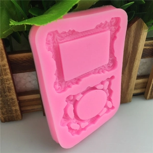 Pink silicone mold featuring two intricate European relief picture frame cavities for fondant