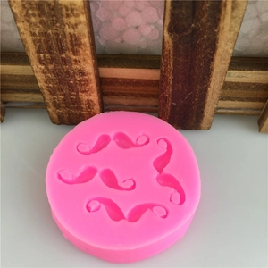 Pink silicone mold featuring multiple mustache shapes for fondant cake decorating