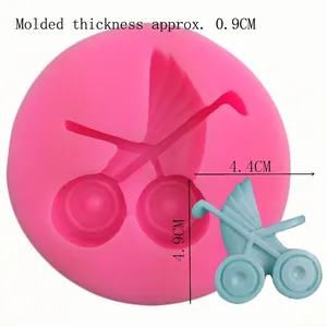 Pink silicone fondant mold featuring a baby stroller design for DIY cake decorating
