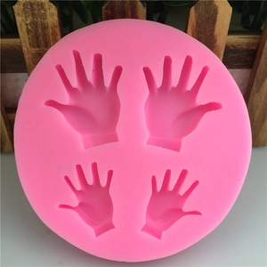 Pink silicone round mold featuring four hand-shaped cavities for DIY fondant cake baking
