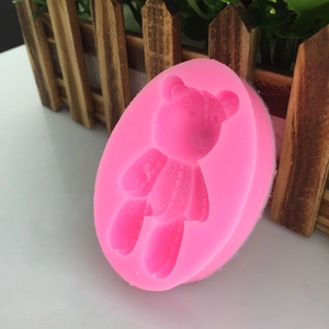 Pink silicone mold featuring an oval shape with a cute 3D bear design for DIY crafts