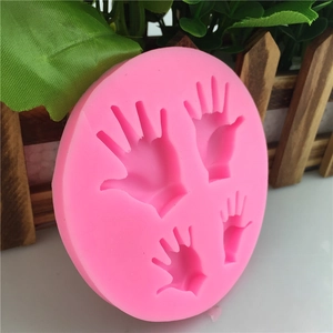 Pink silicone fondant mold featuring four varied handprint shapes for DIY cake decorating