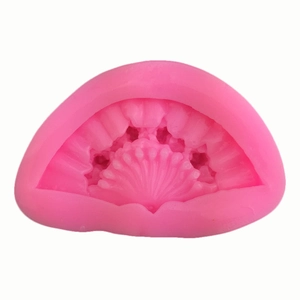 Detailed view of pink silicone fan mold with shell stripes for fondant cake decorating