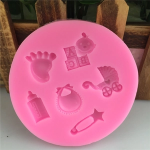 Pink silicone baby themed mold with footprints, stroller and bottle for cake decorating