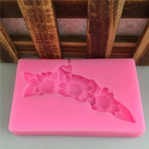 Pink silicone fondant mold with three detailed sunflower patterns for DIY cake baking