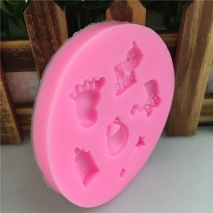 Pink silicone baby shower fondant mold with infant foot and bottle shapes for cake baking