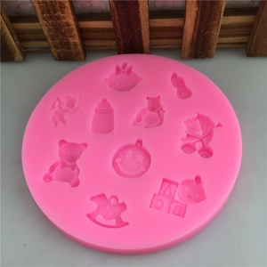 Pink round silicone mold featuring baby motifs like teddy bears and rocking horses