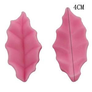 Macro detail of 4cm pink silicone leaf mold showing realistic vein textures for fondant