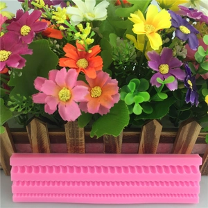Pink silicone fondant mold with wavy border patterns for cake edge decoration