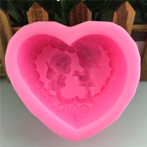 Pink heart-shaped silicone mold featuring embossed cartoon elves and floral wreath