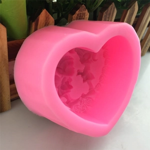 Pink heart-shaped silicone mold with floral and butterfly patterns for DIY fondant cake baking
