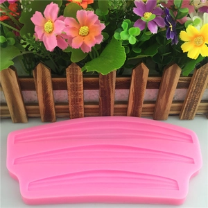Stampo in silicone rosa per decorazioni di bordi torta con motivi a nastro e onde